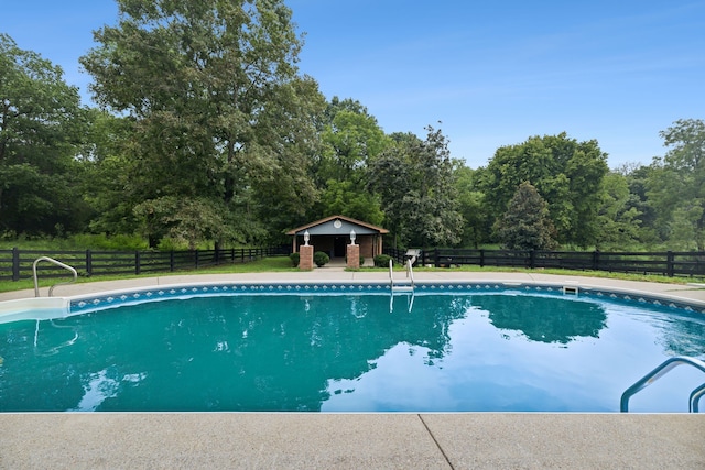 view of swimming pool with an outbuilding