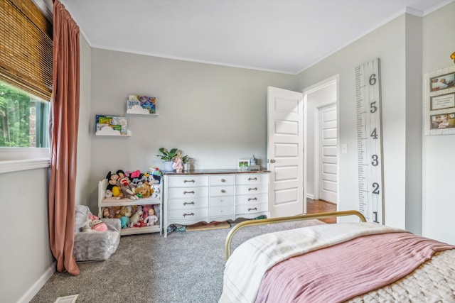 bedroom with crown molding and carpet