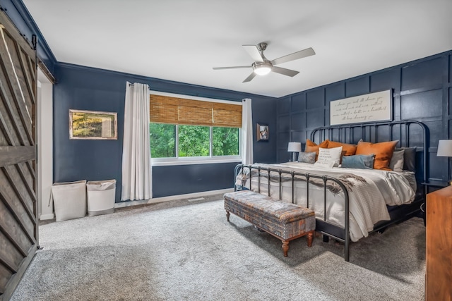 bedroom with carpet floors, ceiling fan, and crown molding