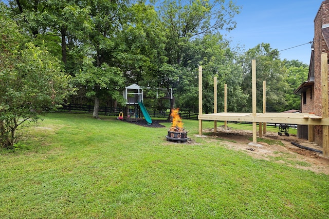 view of yard with a playground and an outdoor fire pit