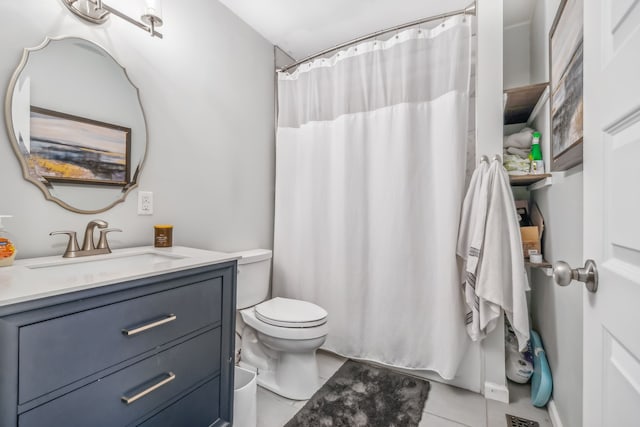 bathroom featuring walk in shower, vanity, tile patterned floors, and toilet