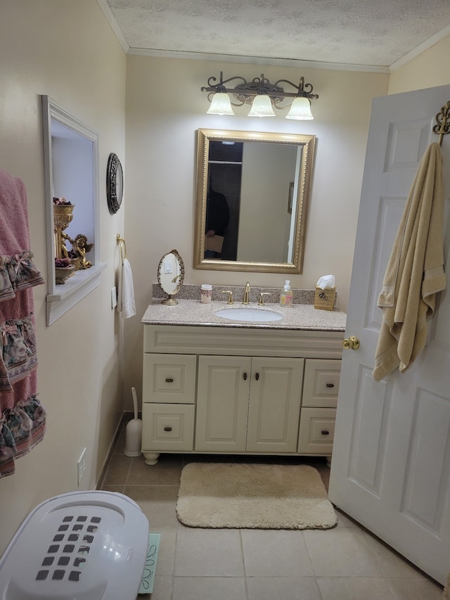 bathroom with vanity, ornamental molding, a textured ceiling, and tile patterned floors