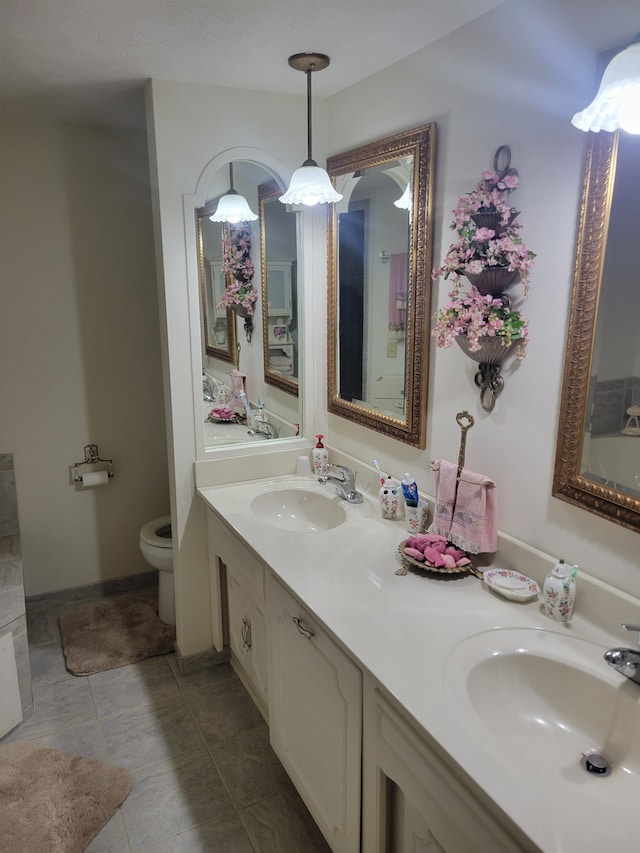 bathroom with vanity, toilet, and tile patterned flooring