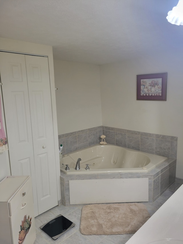 bathroom featuring tile patterned floors and tiled tub