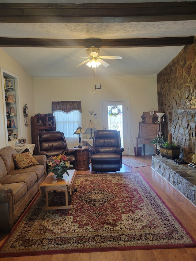 living room with hardwood / wood-style floors, beam ceiling, and ceiling fan