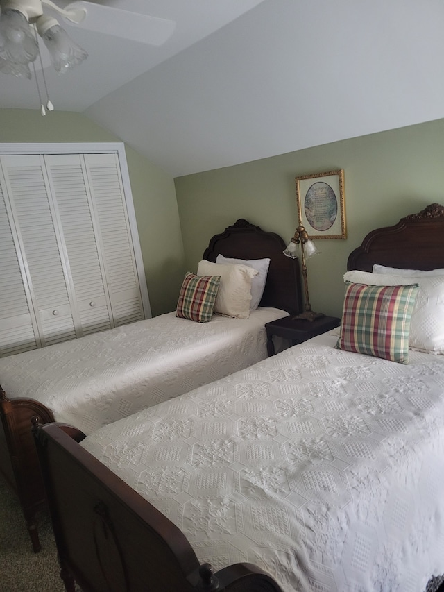 carpeted bedroom featuring a closet, ceiling fan, and lofted ceiling