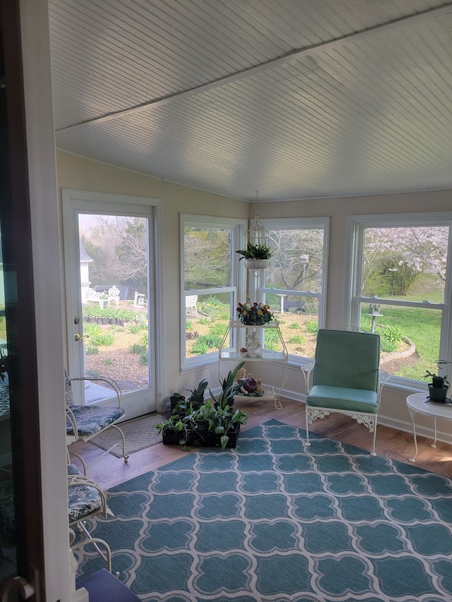 sunroom / solarium featuring lofted ceiling