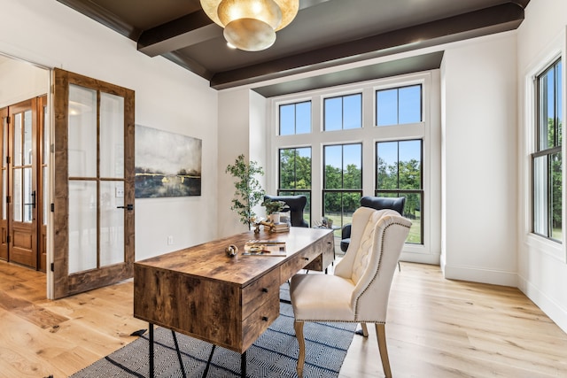 home office with french doors, beamed ceiling, and light wood-type flooring