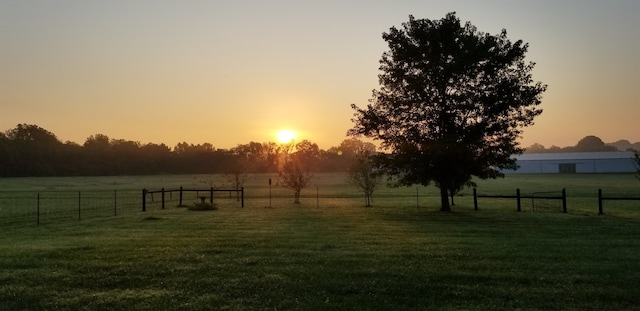 yard at dusk with a rural view