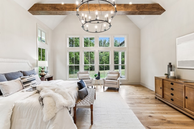 bedroom with high vaulted ceiling, multiple windows, and light hardwood / wood-style floors