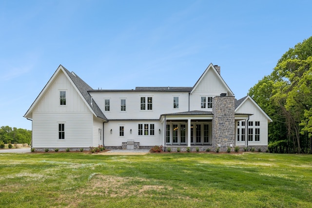 rear view of house featuring a yard and a patio