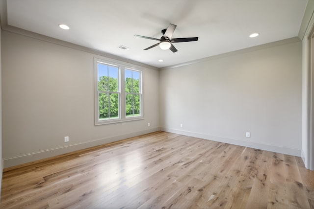 spare room with crown molding, light hardwood / wood-style flooring, and ceiling fan