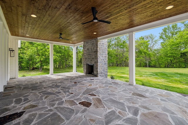 view of patio / terrace with an outdoor brick fireplace and ceiling fan