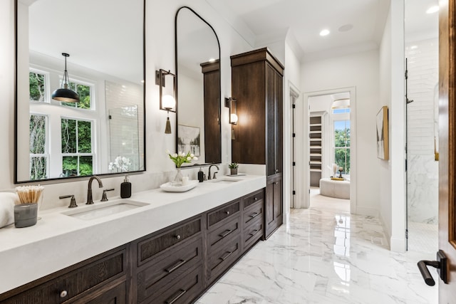 bathroom with vanity, crown molding, and a shower with shower door