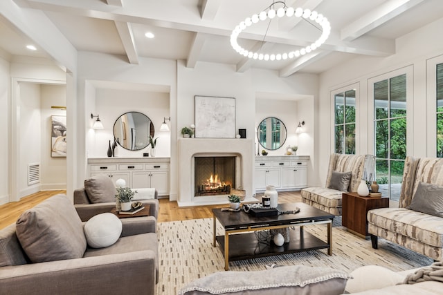 living room with light hardwood / wood-style floors and beamed ceiling