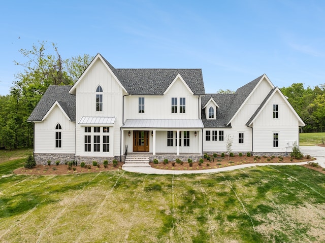 view of front of house with a front yard and a porch