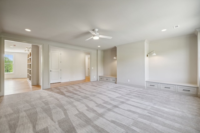 carpeted empty room featuring crown molding and ceiling fan