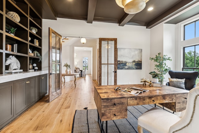 dining space featuring french doors, beam ceiling, and light wood-type flooring