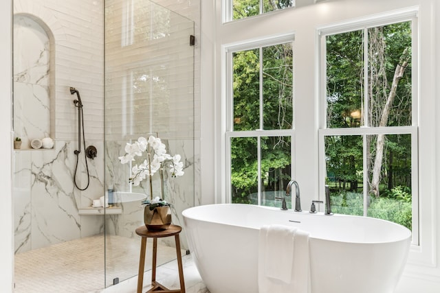 bathroom with separate shower and tub