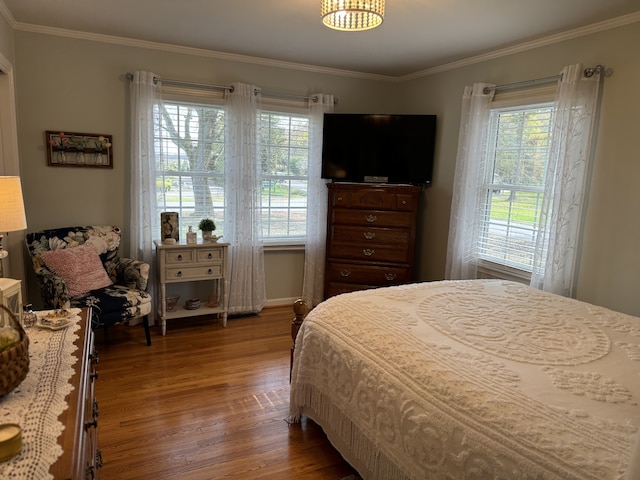 bedroom featuring crown molding and wood-type flooring