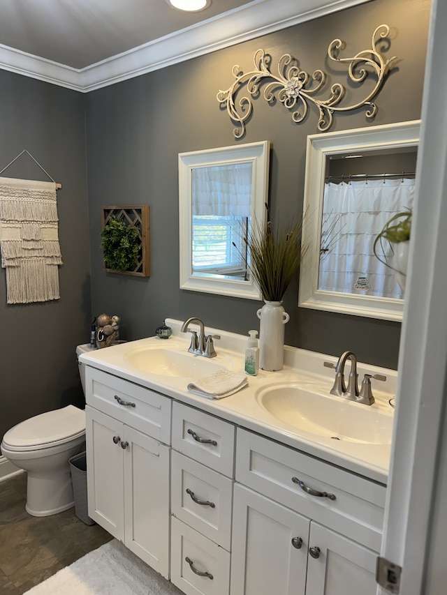 bathroom with vanity, crown molding, and toilet