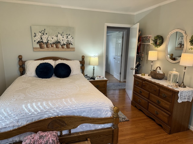 bedroom featuring crown molding and hardwood / wood-style floors