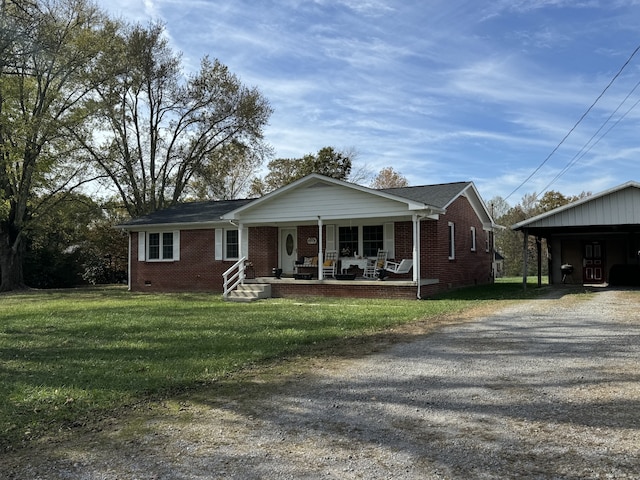 view of front of house with a carport, covered porch, and a front lawn