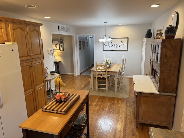 dining room with dark hardwood / wood-style floors and a chandelier