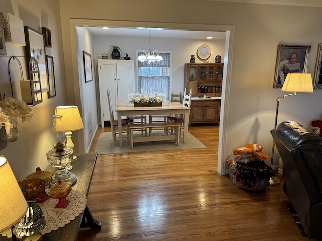 dining space featuring hardwood / wood-style floors and a chandelier