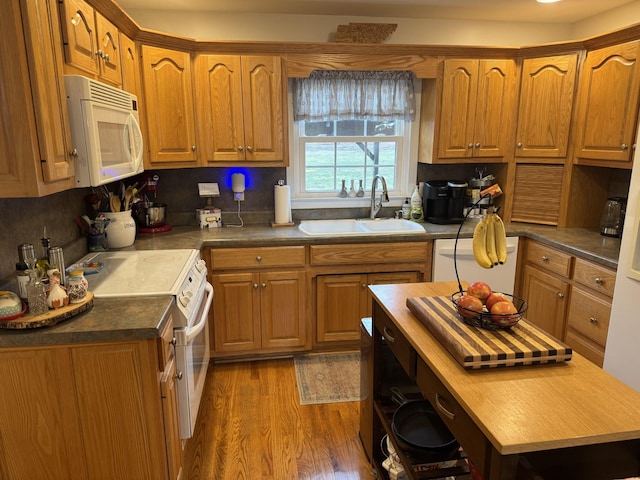 kitchen featuring butcher block counters, sink, white appliances, and light hardwood / wood-style floors