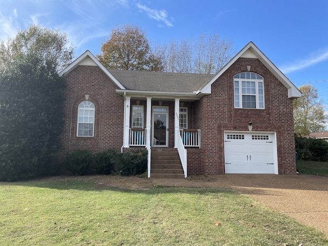 view of front of home with a front lawn, covered porch, and a garage