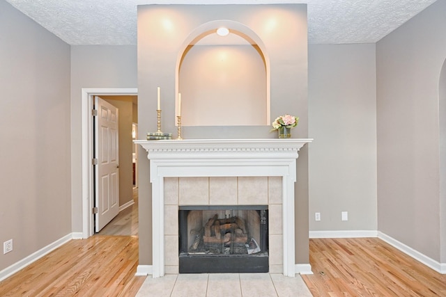 details featuring a fireplace, hardwood / wood-style floors, and a textured ceiling