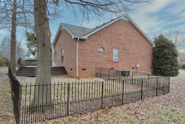 view of side of home featuring central AC