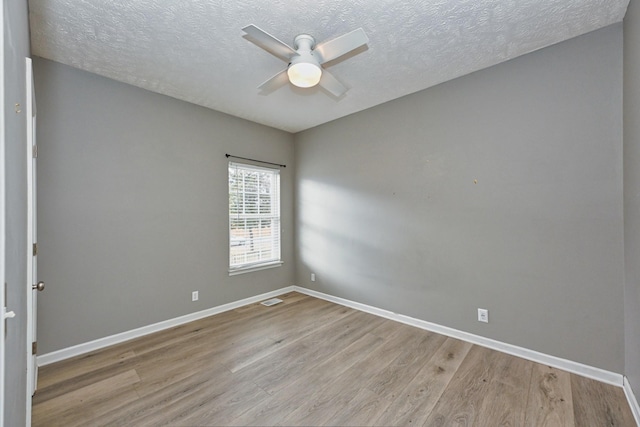 unfurnished room with ceiling fan, light hardwood / wood-style floors, and a textured ceiling