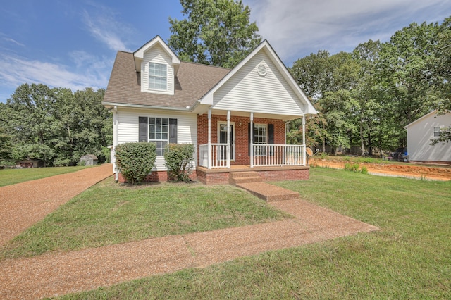 view of front of house with a porch and a front yard