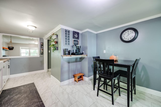 dining space with crown molding