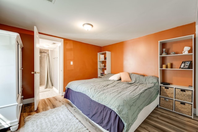 bedroom with hardwood / wood-style floors