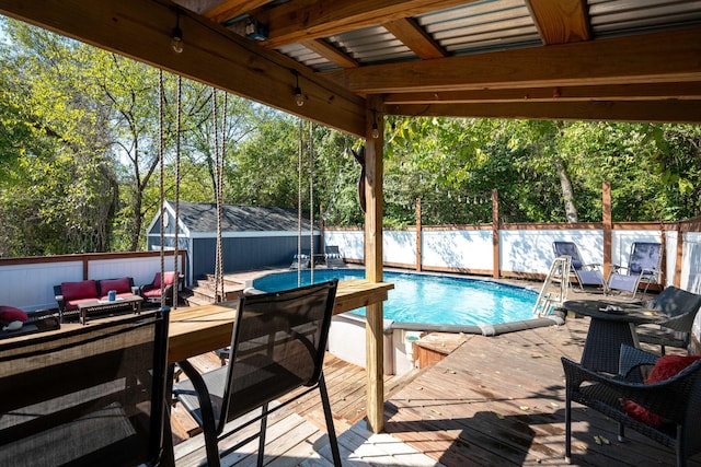 view of swimming pool featuring an outdoor structure, a wooden deck, and an outdoor hangout area