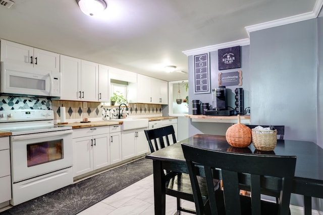 kitchen featuring decorative backsplash, sink, crown molding, white cabinetry, and white appliances