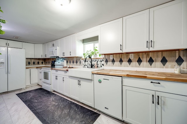 kitchen with sink, white cabinetry, white appliances, and butcher block counters