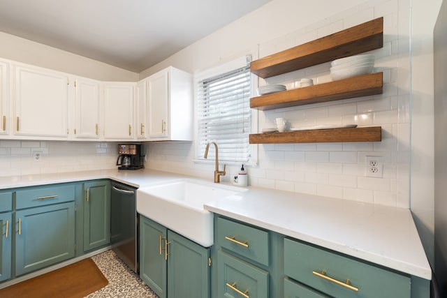 kitchen with stainless steel dishwasher, sink, white cabinets, and tasteful backsplash