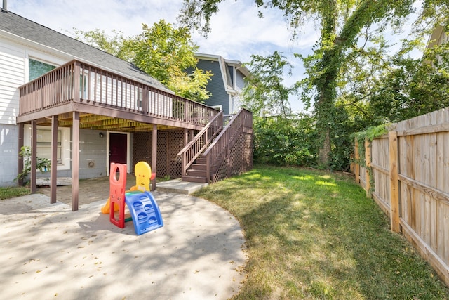 view of yard with a wooden deck and a patio