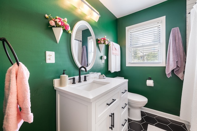 bathroom featuring vanity and toilet