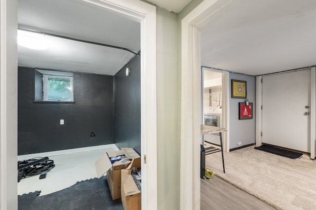 interior space with washer / clothes dryer and hardwood / wood-style floors