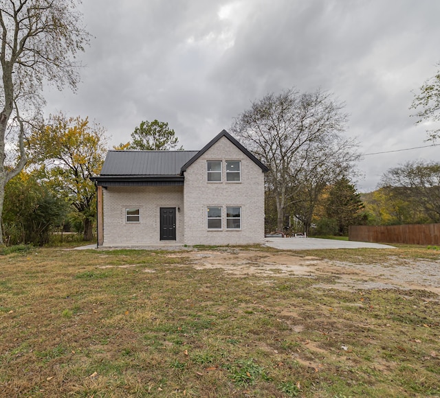 back of house with a patio area and a yard