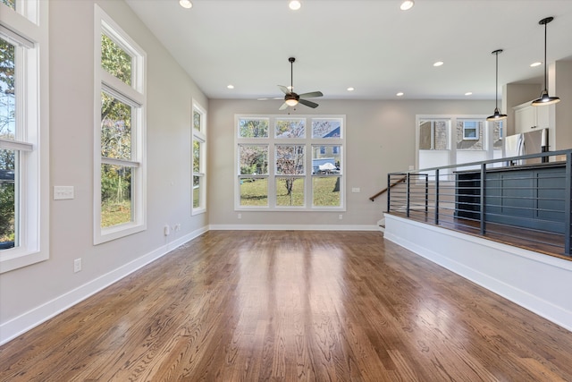 unfurnished living room with hardwood / wood-style floors and ceiling fan