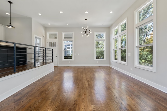 interior space featuring dark wood-type flooring and an inviting chandelier