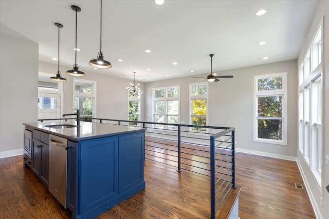 kitchen featuring blue cabinetry, dishwasher, sink, and dark wood-type flooring