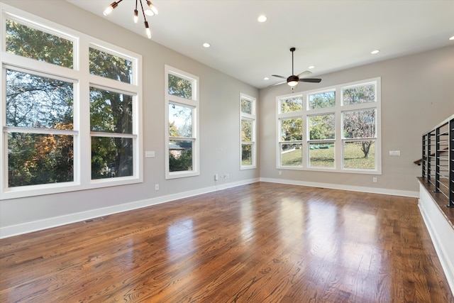 unfurnished living room with ceiling fan and dark hardwood / wood-style floors