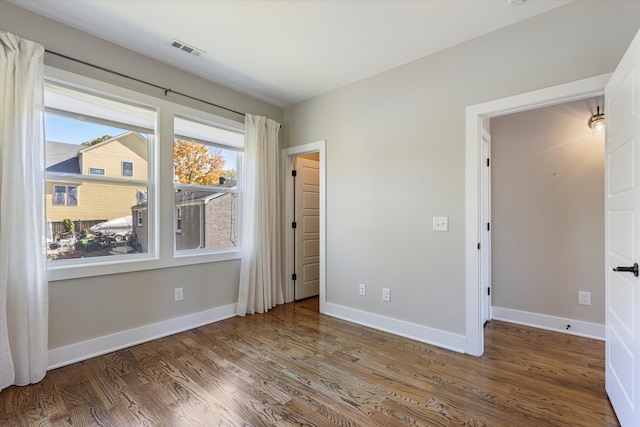 spare room with dark hardwood / wood-style flooring